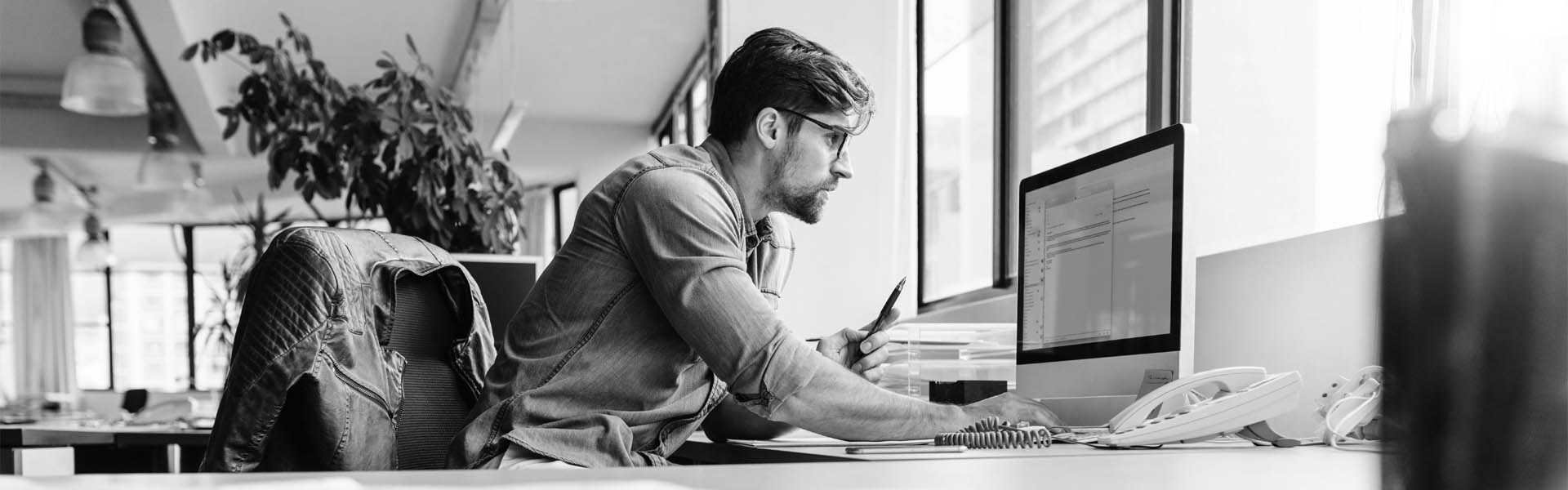 man staring intently at computer