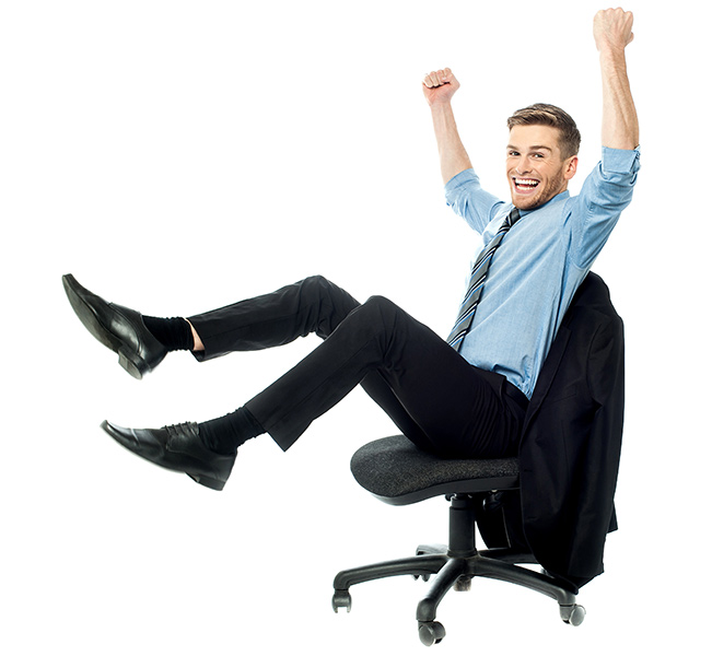 man dressed for work sitting in an office chair with his arms and feet in the air