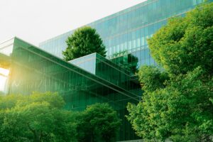 corporate office building surrounded by leafy green trees
